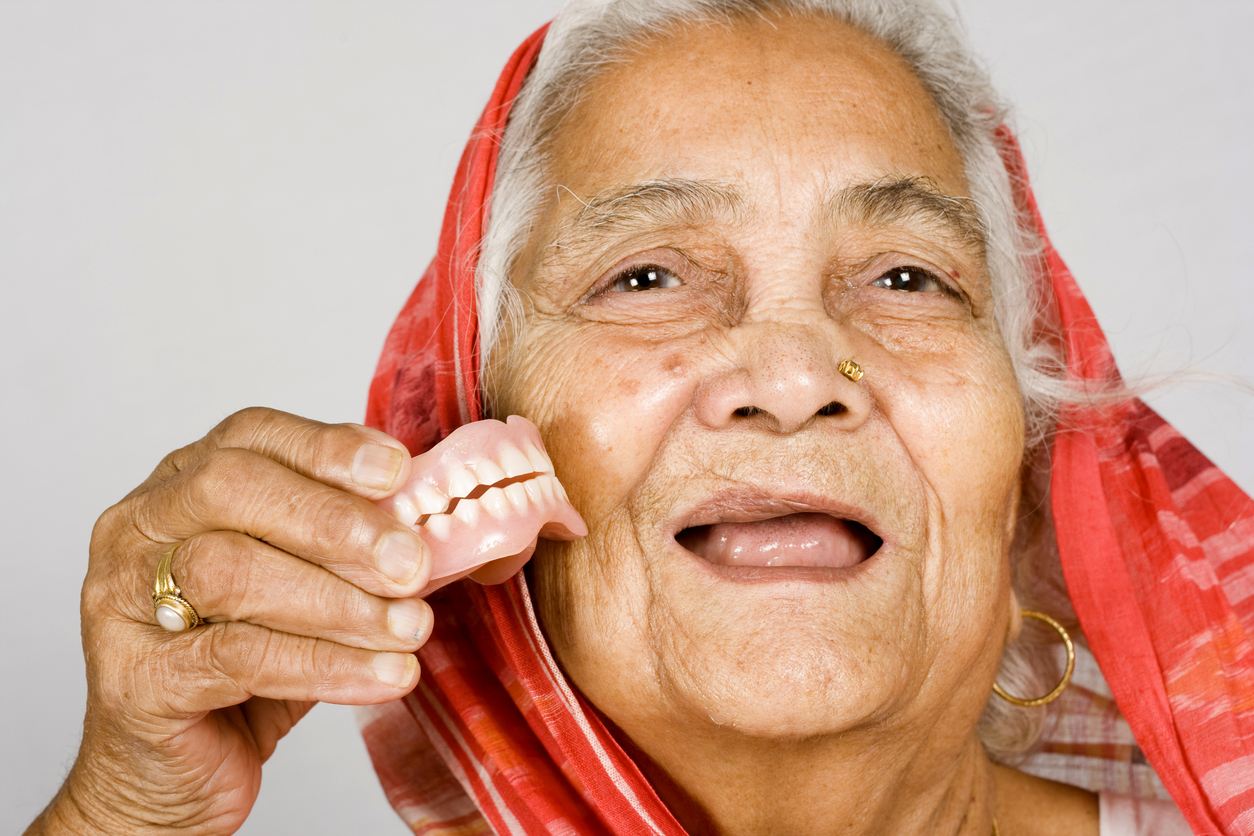 Senior Indian Woman showing her Denture Health Problems Smile Makers